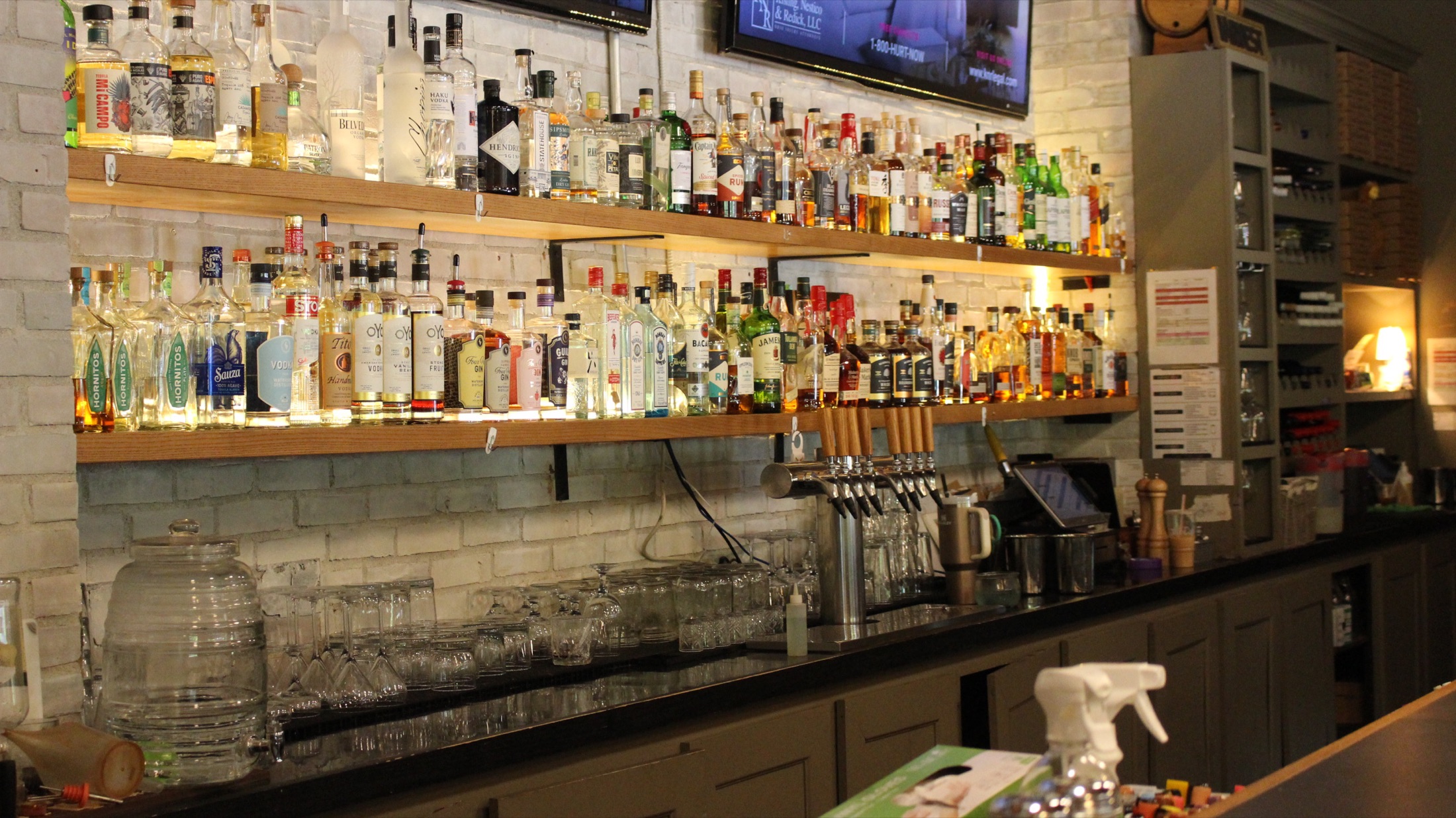 Brewery District back bar with full spirits shelves and draft taps